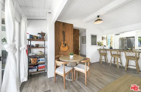a view of a dining room with furniture and a window