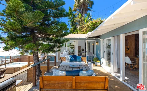 a balcony with wooden floor and furniture