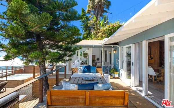 a balcony with wooden floor and furniture