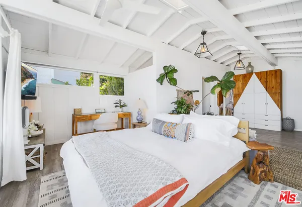 a bedroom with a bed and a large window