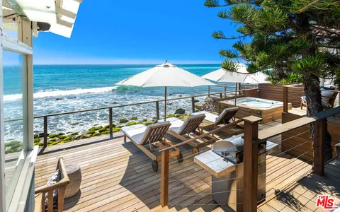 a view of a house with roof deck and sitting area