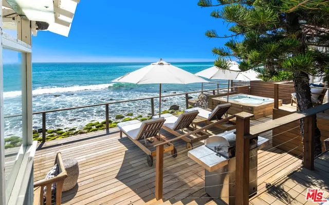 a view of a house with roof deck and sitting area