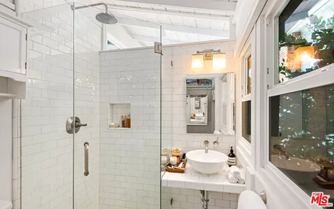 an aerial view of a house with a yard and a large tree