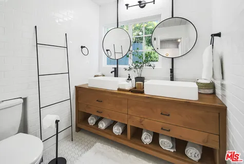 a view of a patio with couches and table and chairs with wooden floor