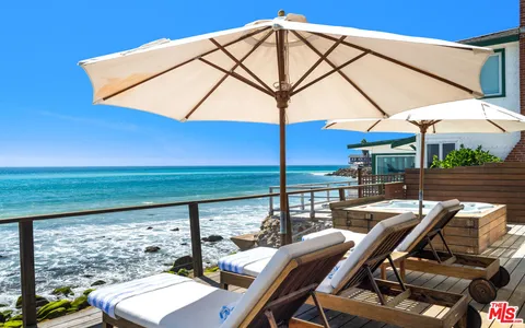 a living room with furniture kitchen view and a window