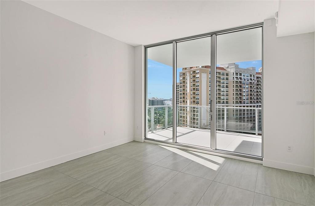 301 Quay Commons, Unit 1011 Sarasota, FL 34236 - Photo 21 of 75 a view of an empty room with glass door