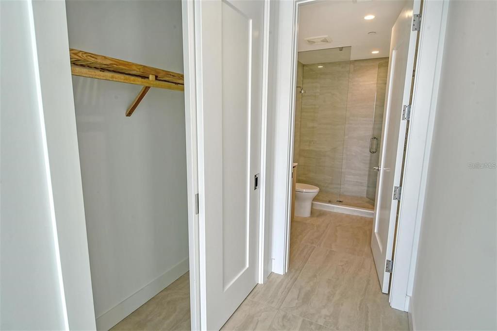 301 Quay Commons, Unit 1011 Sarasota, FL 34236 - Photo 30 of 75 a bathroom with a glass shower door