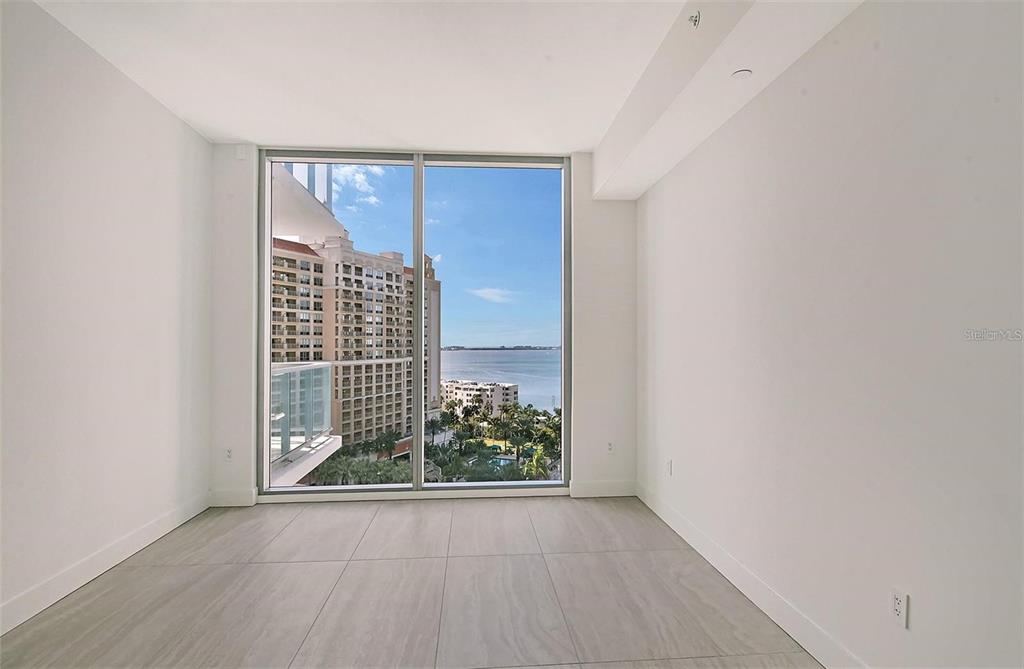 301 Quay Commons, Unit 1011 Sarasota, FL 34236 - Photo 32 of 75 a view of a room with wooden floor and a window