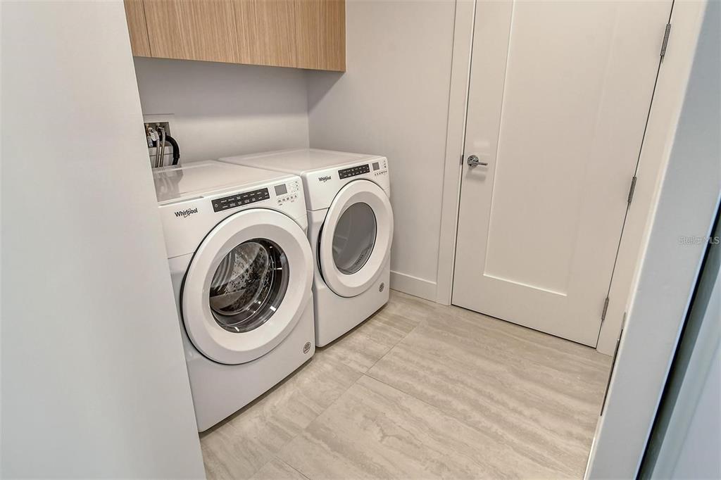 301 Quay Commons, Unit 1011 Sarasota, FL 34236 - Photo 35 of 75 a utility room with dryer and washer