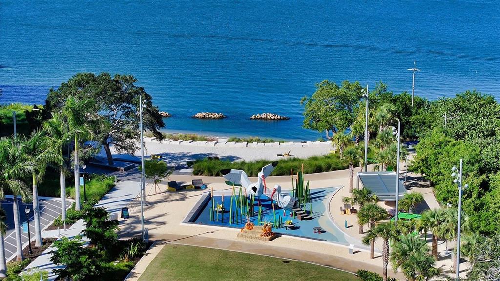 301 Quay Commons, Unit 1011 Sarasota, FL 34236 - Photo 46 of 75 an aerial view of a house with outdoor space pool seating area and covered with tall trees