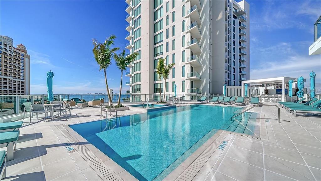 301 Quay Commons, Unit 1011 Sarasota, FL 34236 - Photo 64 of 75 a view of a swimming pool with outdoor seating