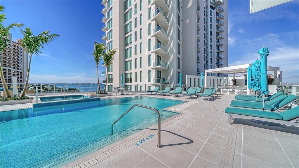 301 Quay Commons, Unit 1011 Sarasota, FL 34236 - Photo 71 of 75 a view of swimming pool with outdoor seating and plants
