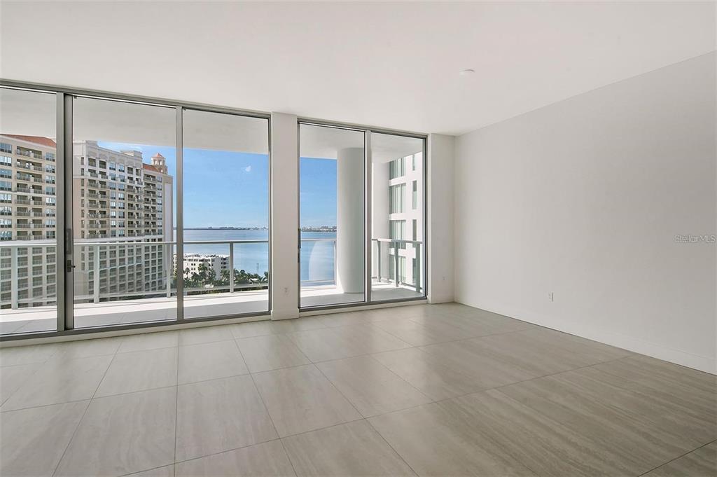 301 Quay Commons, Unit 1011 Sarasota, FL 34236 - Photo 9 of 75 a view of an empty room with glass door