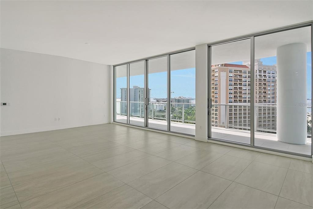 301 Quay Commons, Unit 1011 Sarasota, FL 34236 - Photo 10 of 75 a view of an empty room with a sliding door