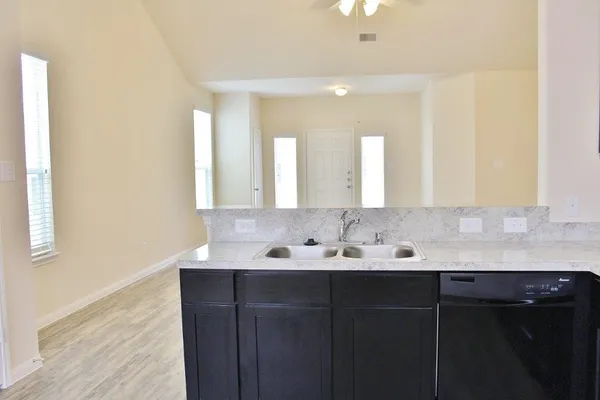 a bathroom with a double vanity sink and a mirror