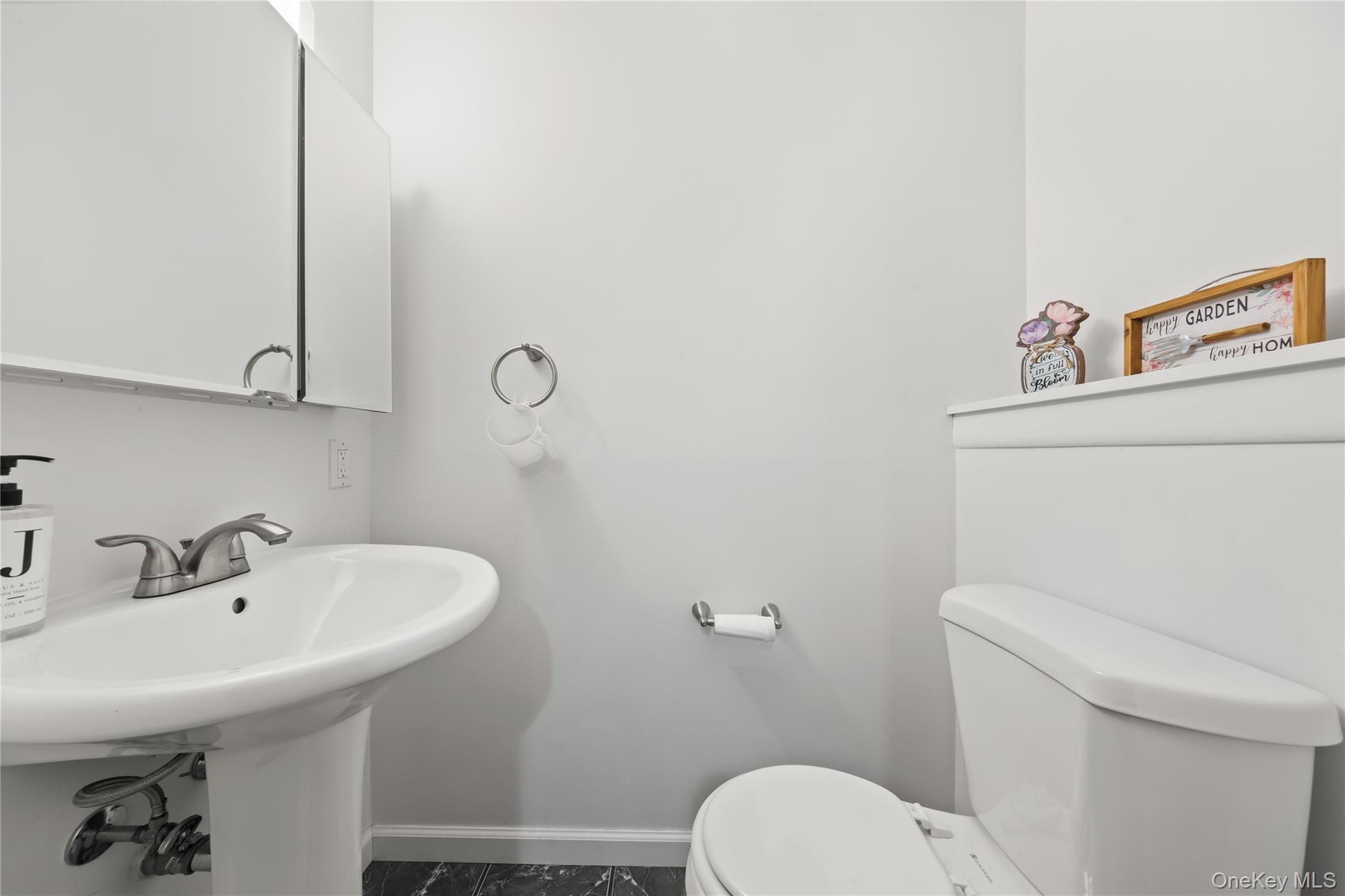 11 Castle Drive Chestnut Ridge, NY 10977 - Photo 32 of 34 a bathroom with a sink a toilet and mirror