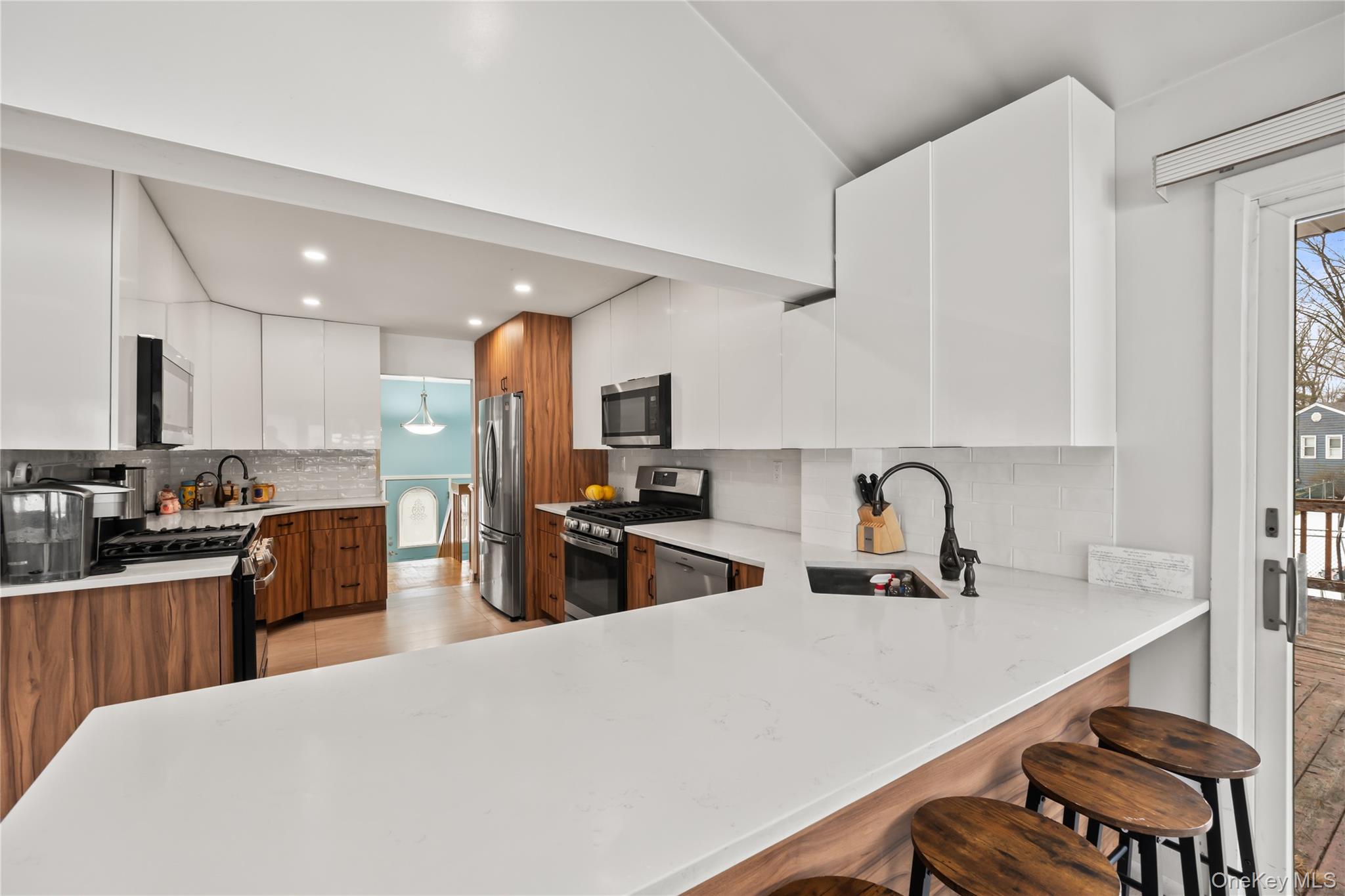 11 Castle Drive Chestnut Ridge, NY 10977 - Photo 10 of 34 a kitchen with sink refrigerator and stove