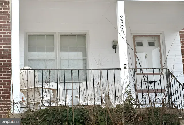 a view of staircase with railing and a window