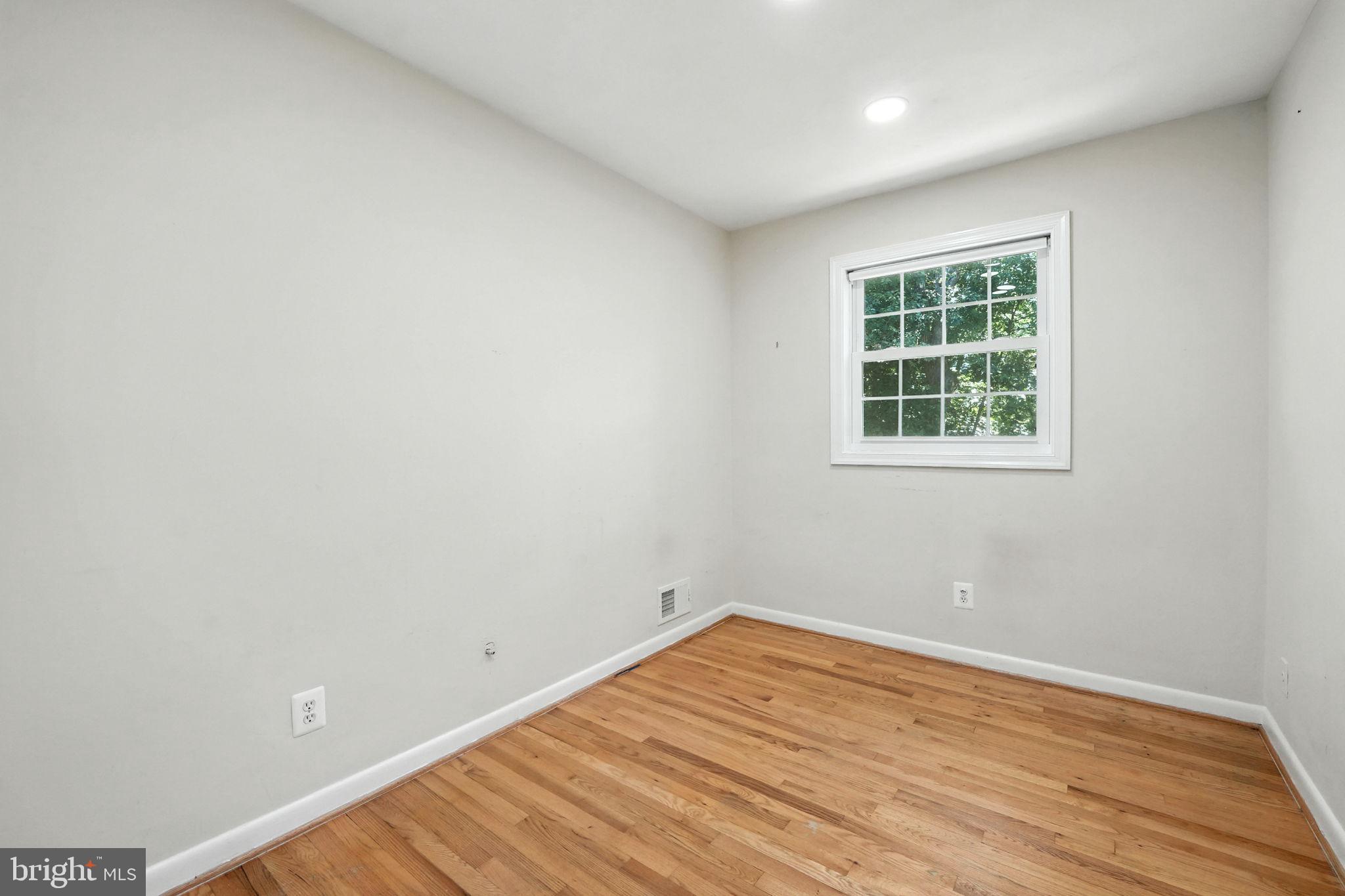 5206 Easton Drive Springfield, VA 22151 - Photo 16 of 39 an empty room with wooden floor and windows