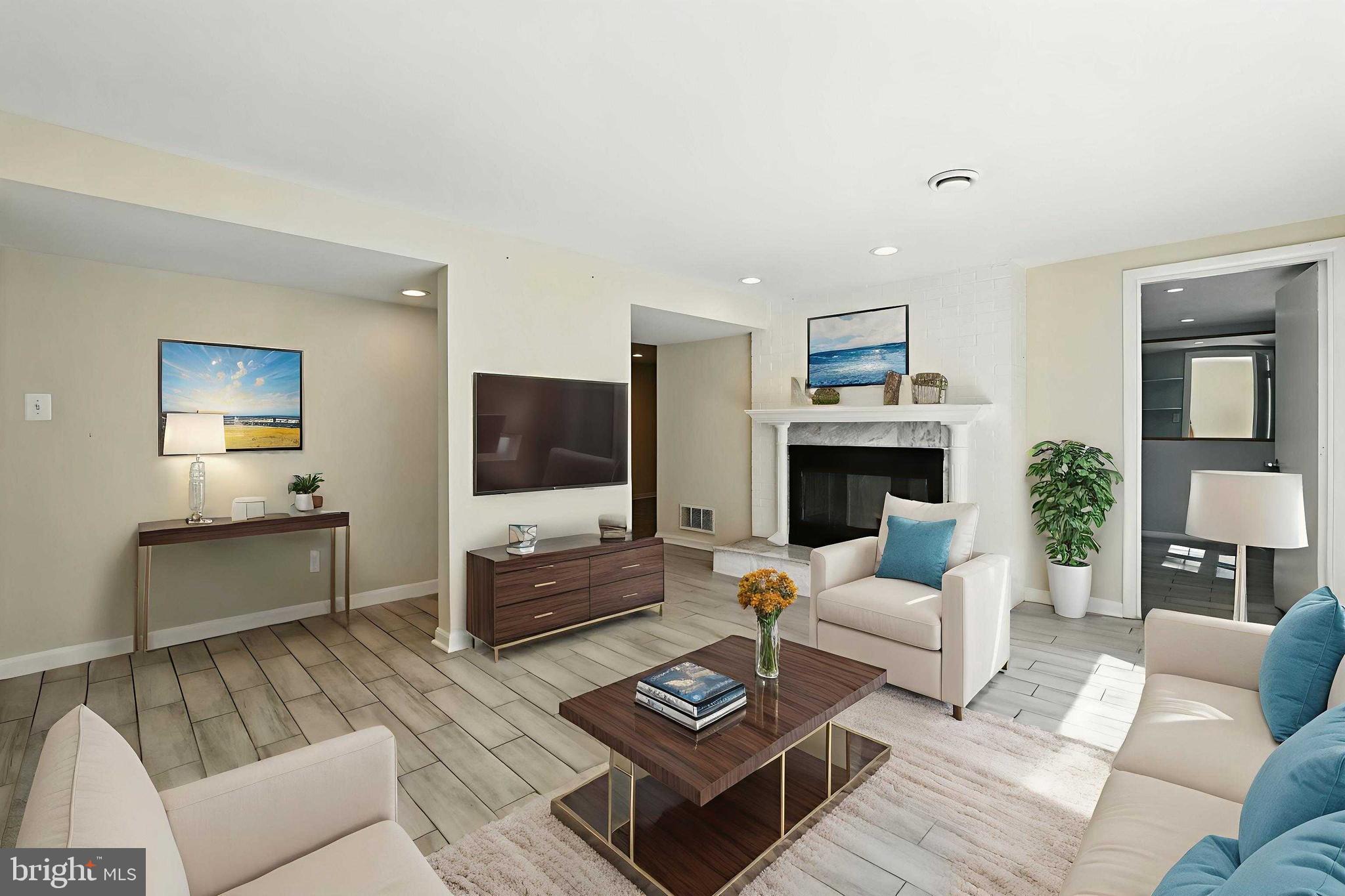 5206 Easton Drive Springfield, VA 22151 - Photo 25 of 39 a living room with furniture a flat screen tv and a fireplace