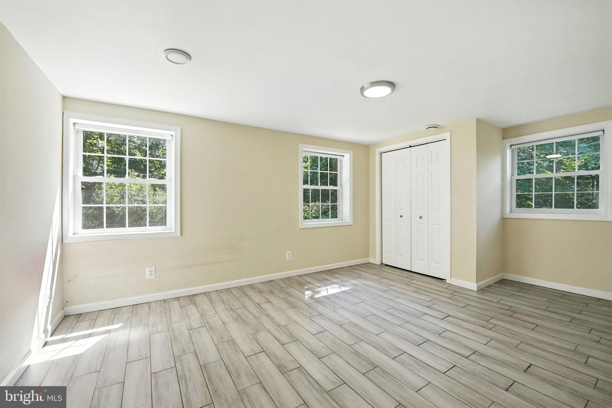 5206 Easton Drive Springfield, VA 22151 - Photo 28 of 39 an empty room with wooden floor and windows