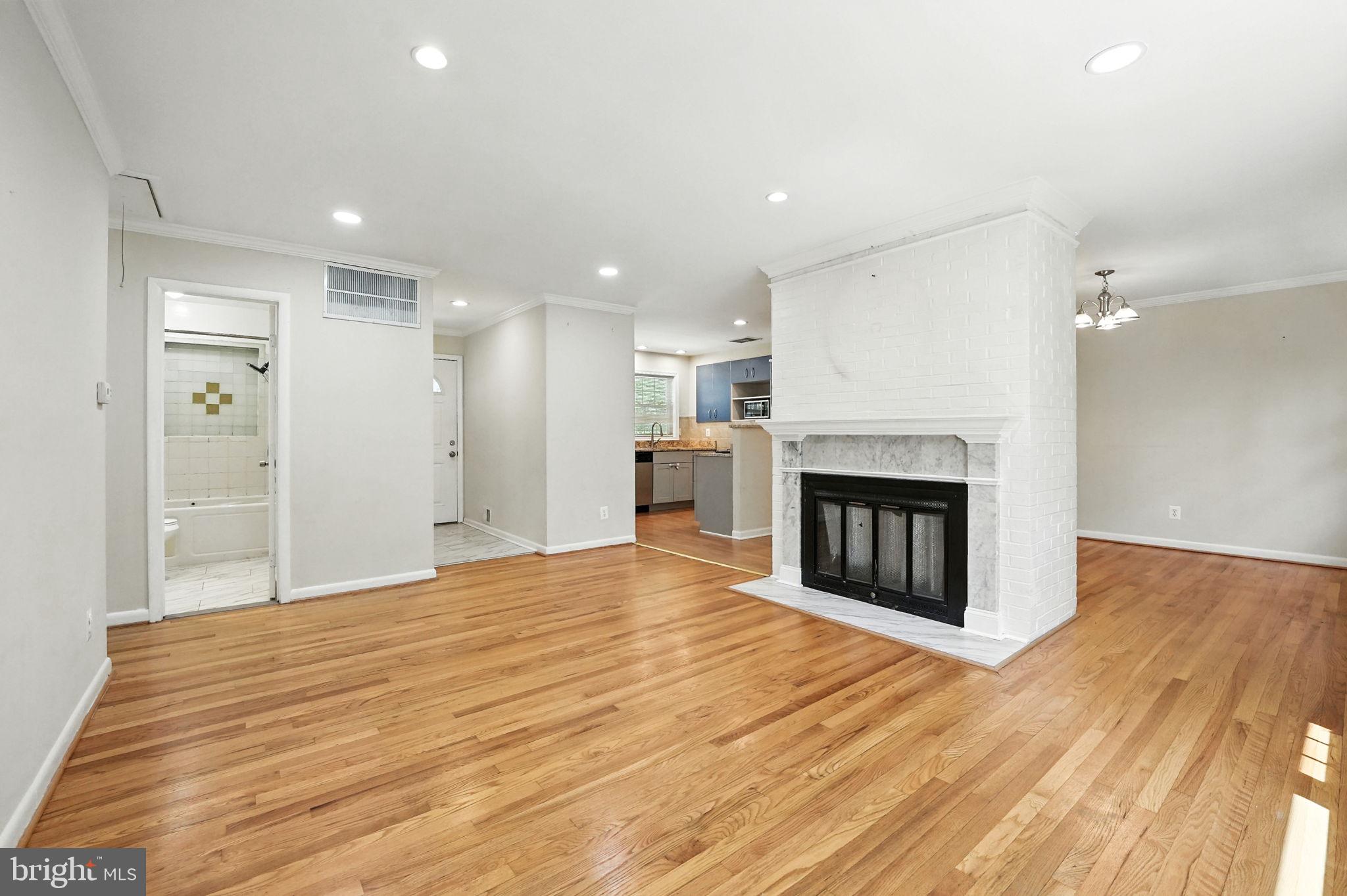 5206 Easton Drive Springfield, VA 22151 - Photo 5 of 39 a view of an empty room with wooden floor fireplace and a window