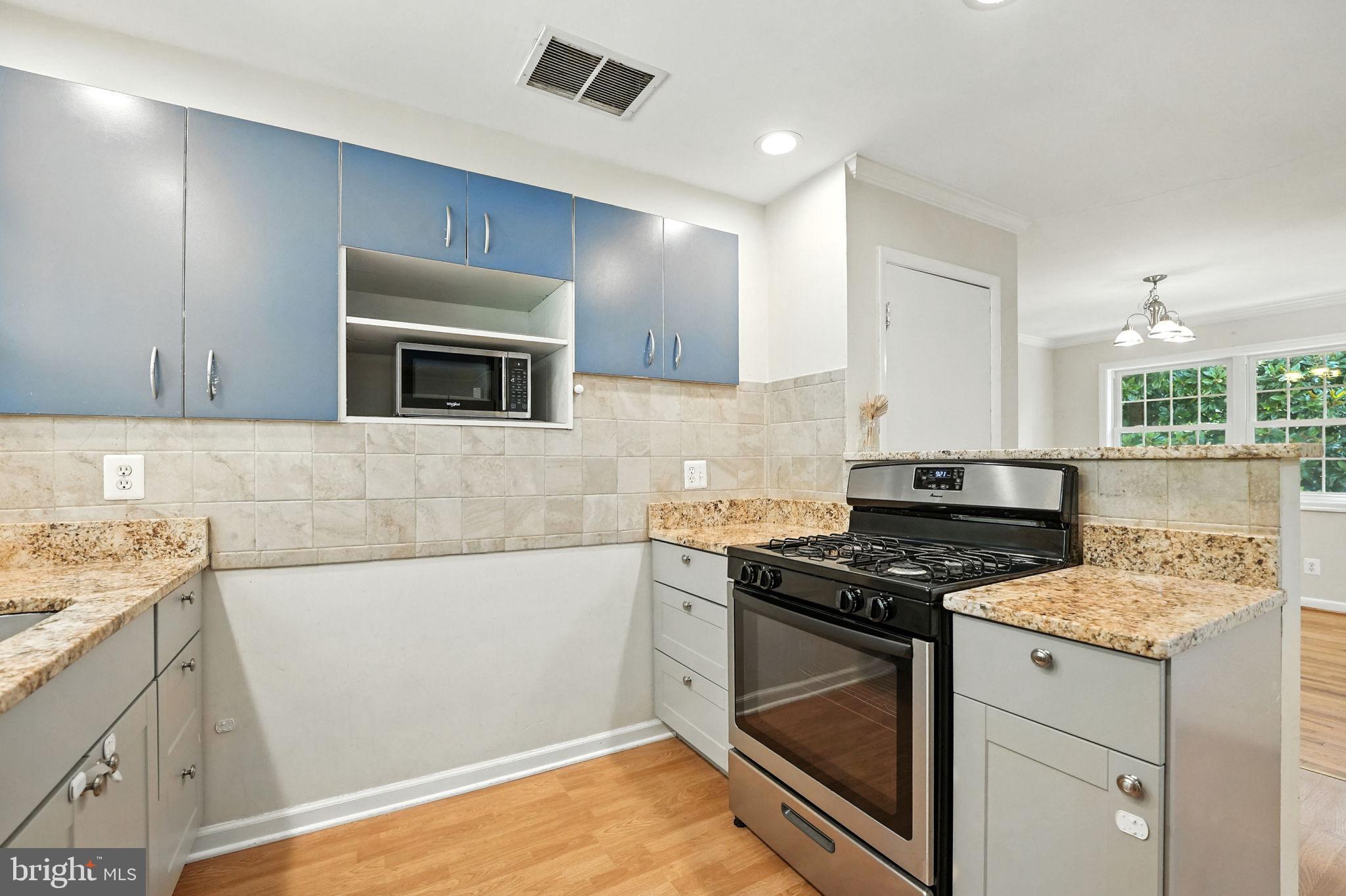 5206 Easton Drive Springfield, VA 22151 - Photo 10 of 39 a kitchen with granite countertop a stove and a sink