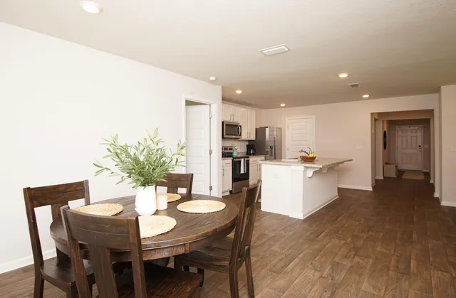 a view of a dining room with furniture and wooden floor