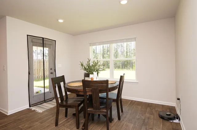 a living room with kitchen island furniture and a flat screen tv