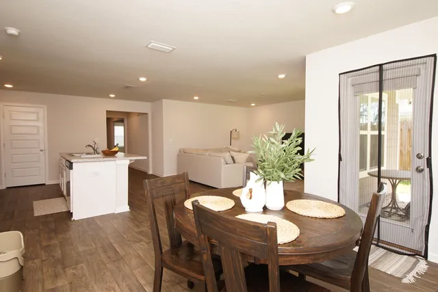 a living room with furniture and kitchen view