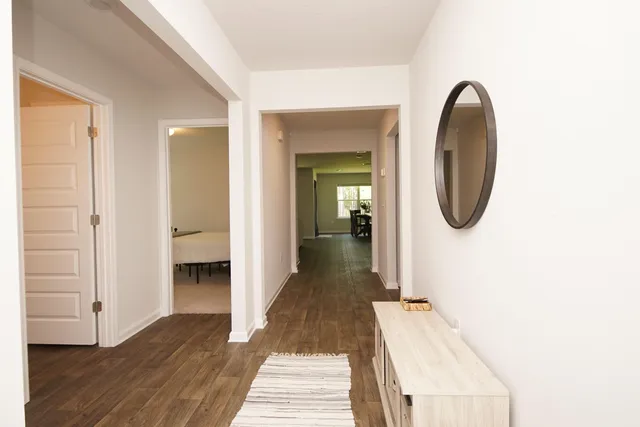 a view of a room with wooden floor and white walls