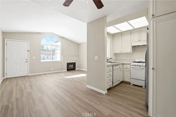 a view of a kitchen with wooden floor and a window