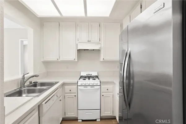 a kitchen with a sink appliances and cabinets