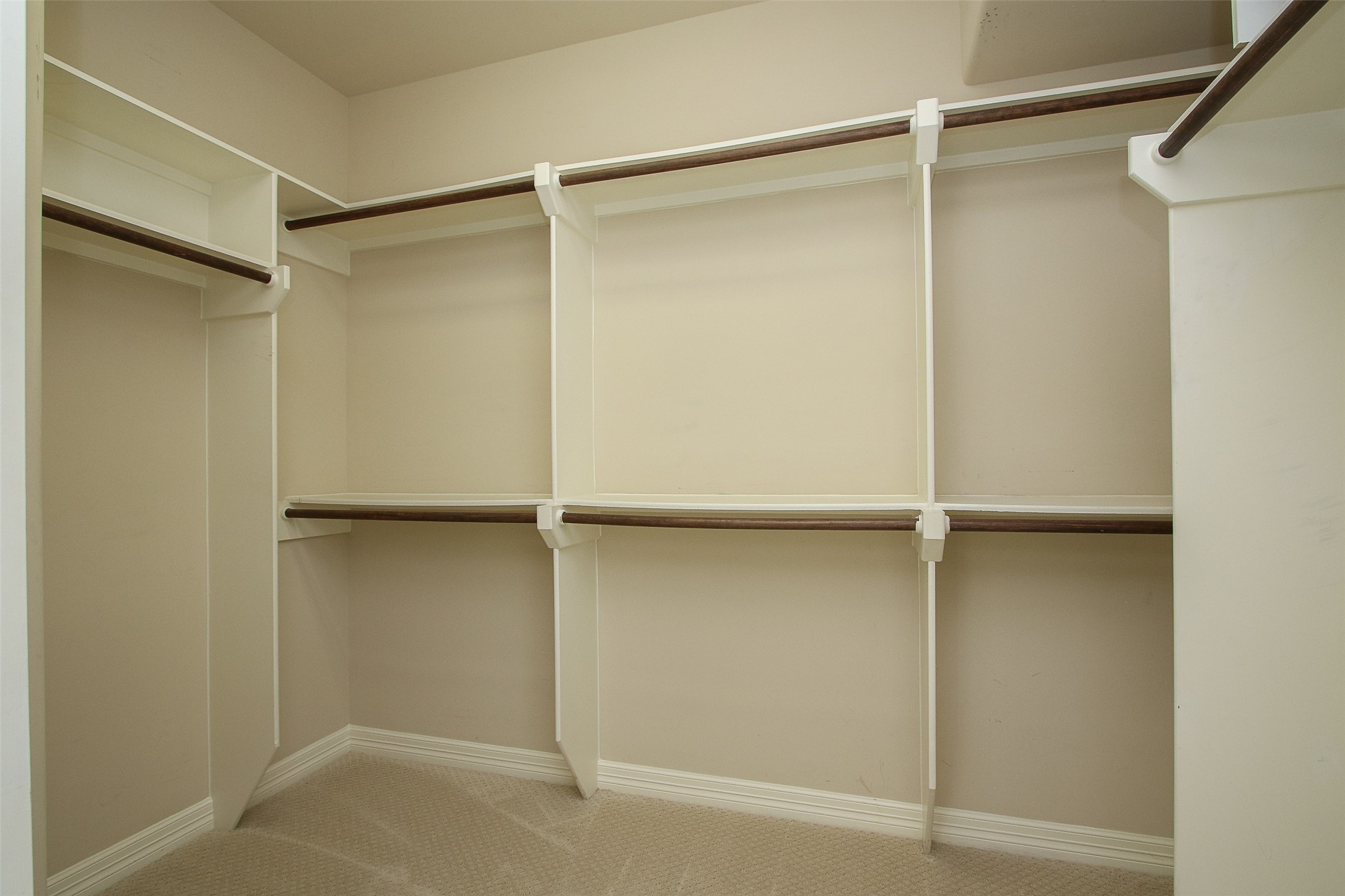 11722 Spriggs Way Houston, TX 77024 - Photo 27 of 49 Plenty of place for clothes in this primary closet plus shelves (not shown)