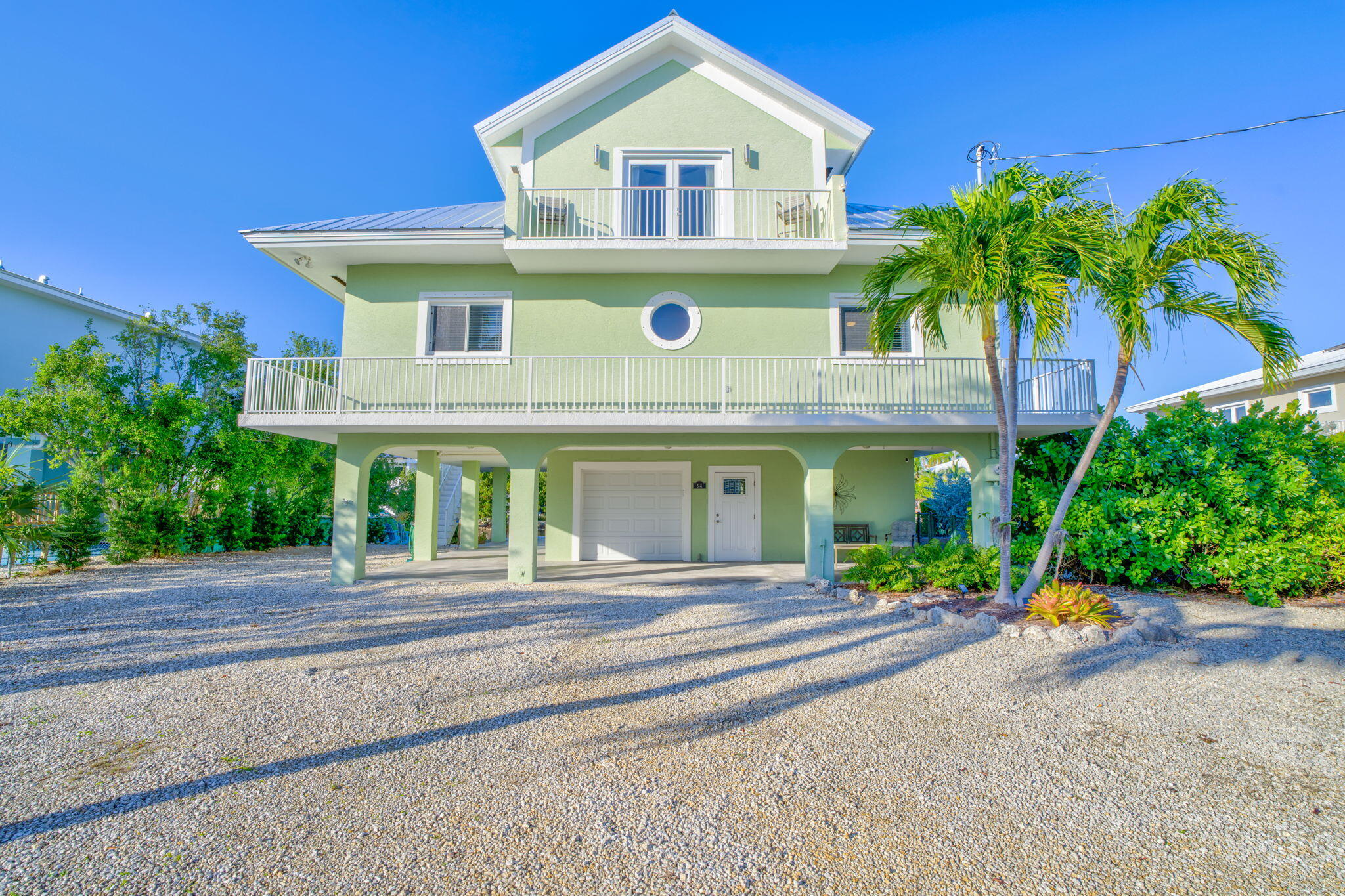 24 Mutiny Place Key Largo, FL 33037 - Photo 3 of 57 a front view of a house with a yard