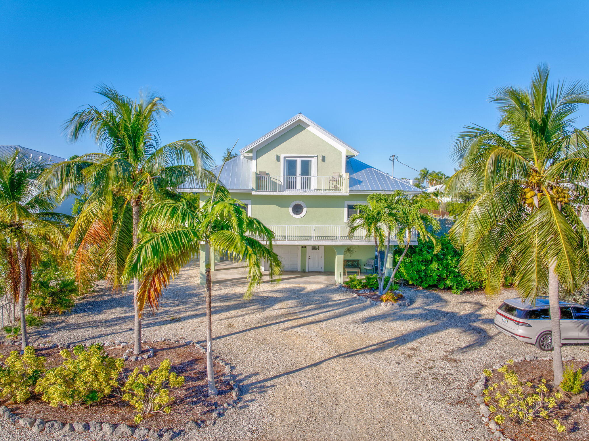 24 Mutiny Place Key Largo, FL 33037 - Photo 40 of 57 a front view of a house with a yard and a garage