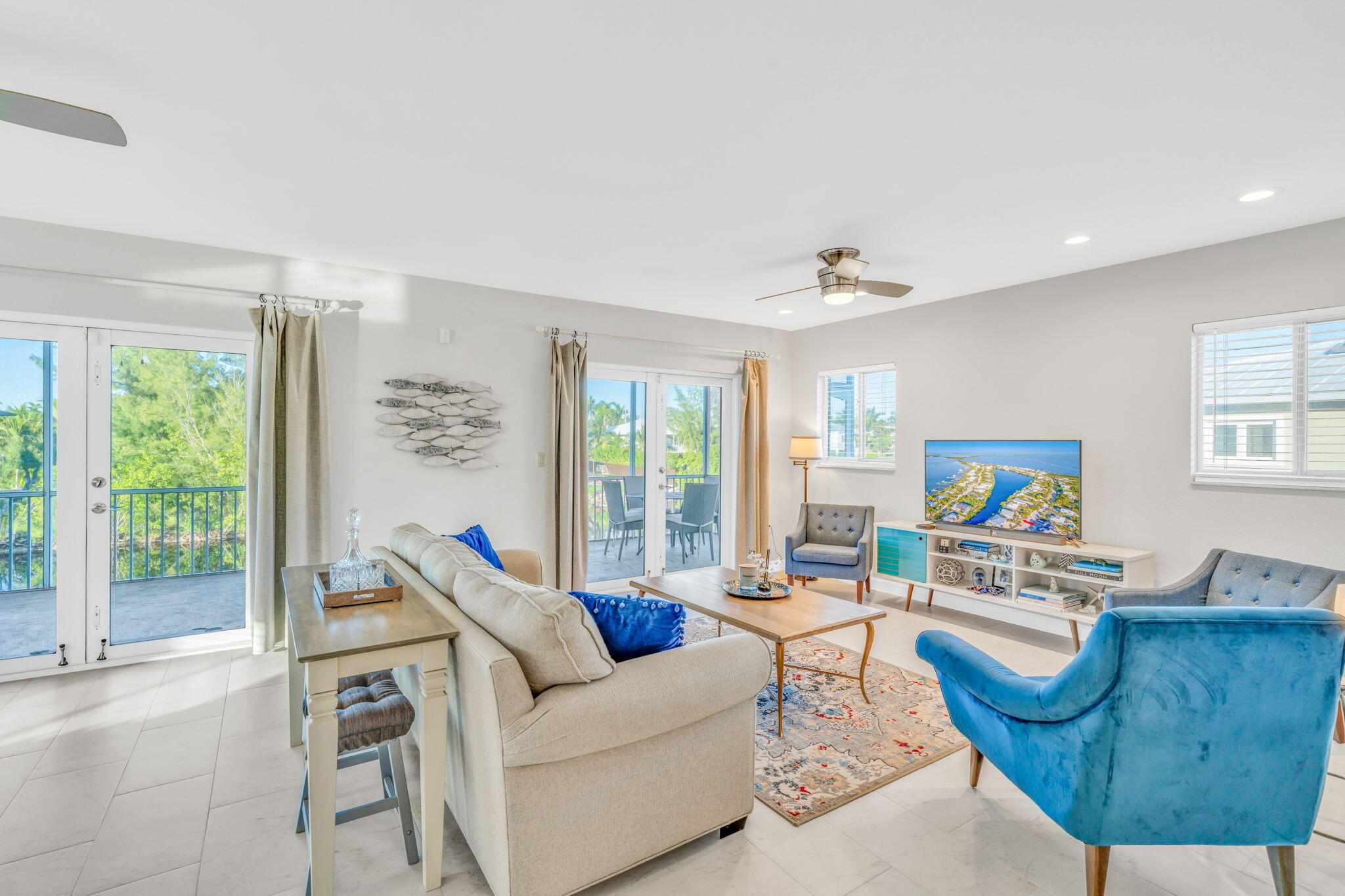 24 Mutiny Place Key Largo, FL 33037 - Photo 5 of 57 a living room with furniture a flat screen tv and a large window
