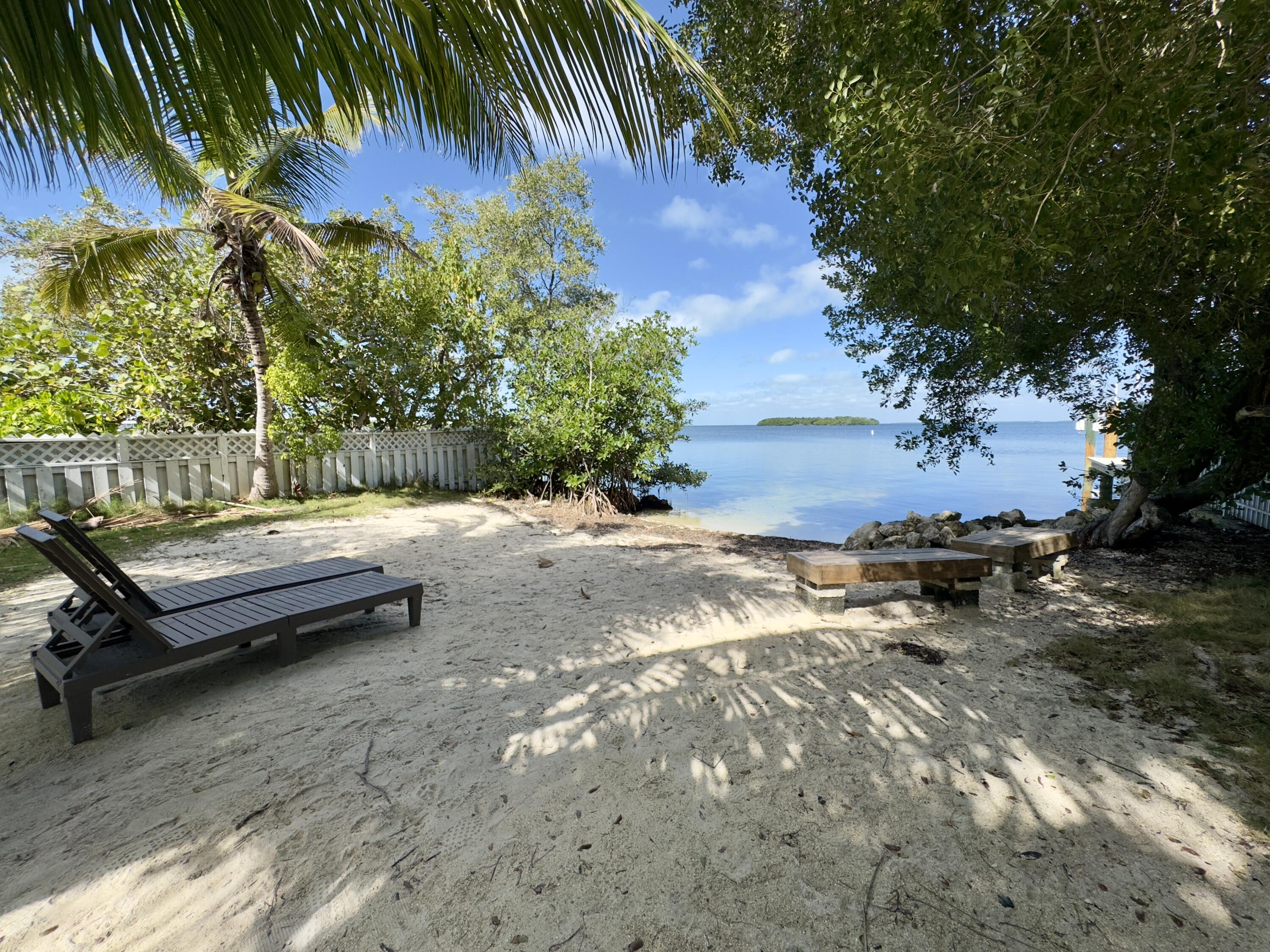 24 Mutiny Place Key Largo, FL 33037 - Photo 56 of 57 a backyard of a house with outdoor seating