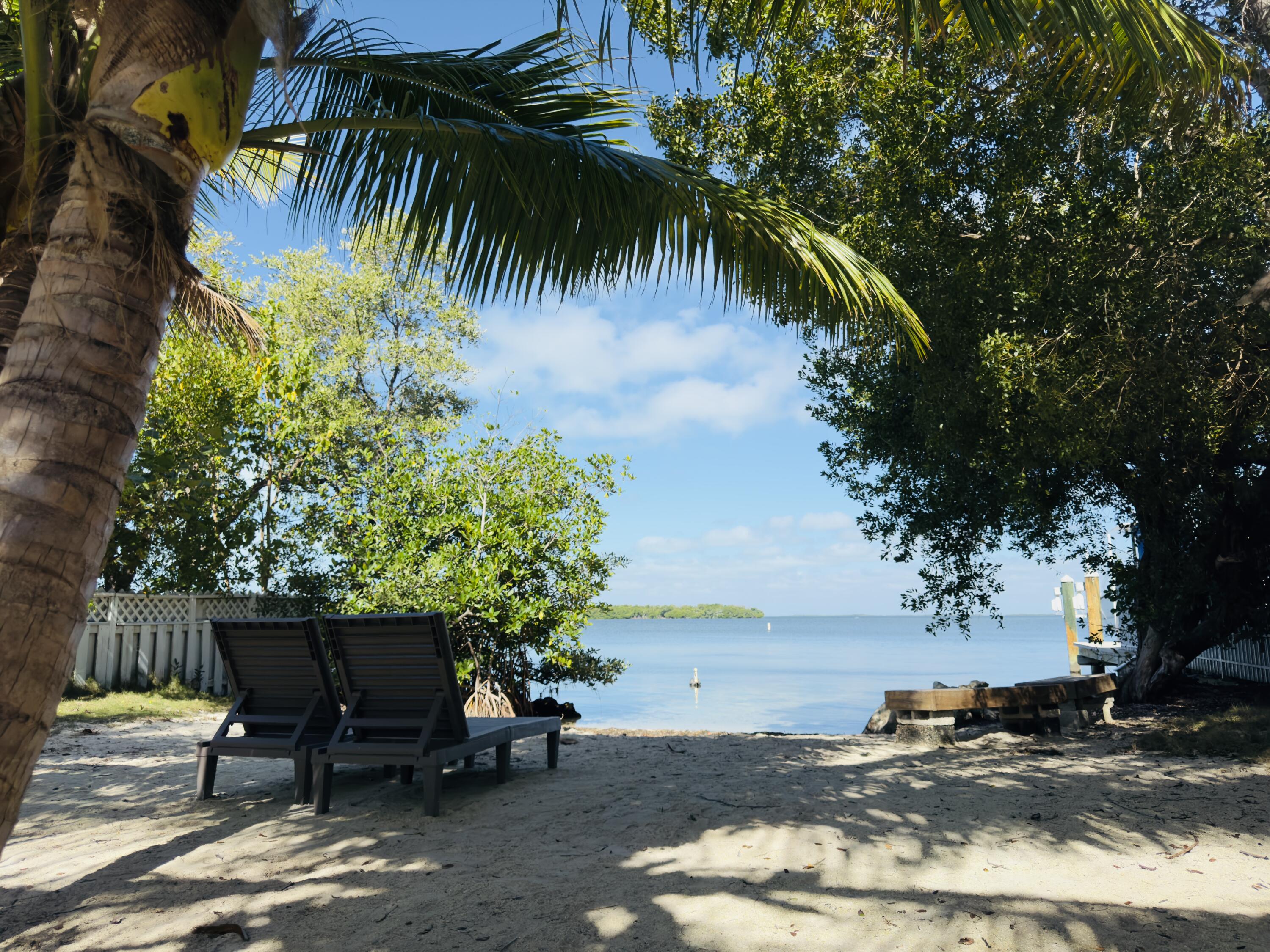24 Mutiny Place Key Largo, FL 33037 - Photo 57 of 57 a backyard of a house with table and chairs