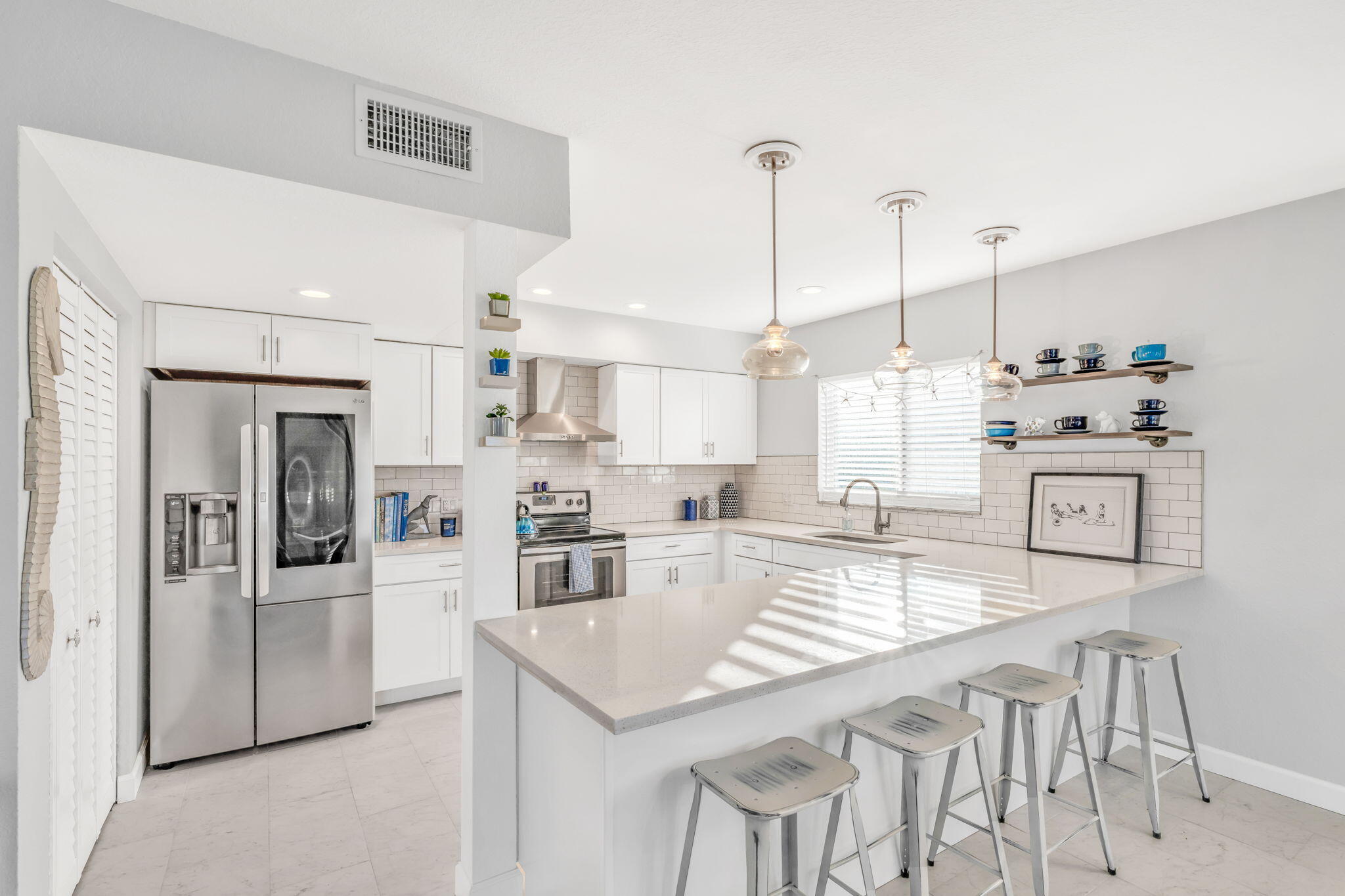 24 Mutiny Place Key Largo, FL 33037 - Photo 8 of 57 a kitchen with stainless steel appliances kitchen island granite countertop a table chairs and a refrigerator