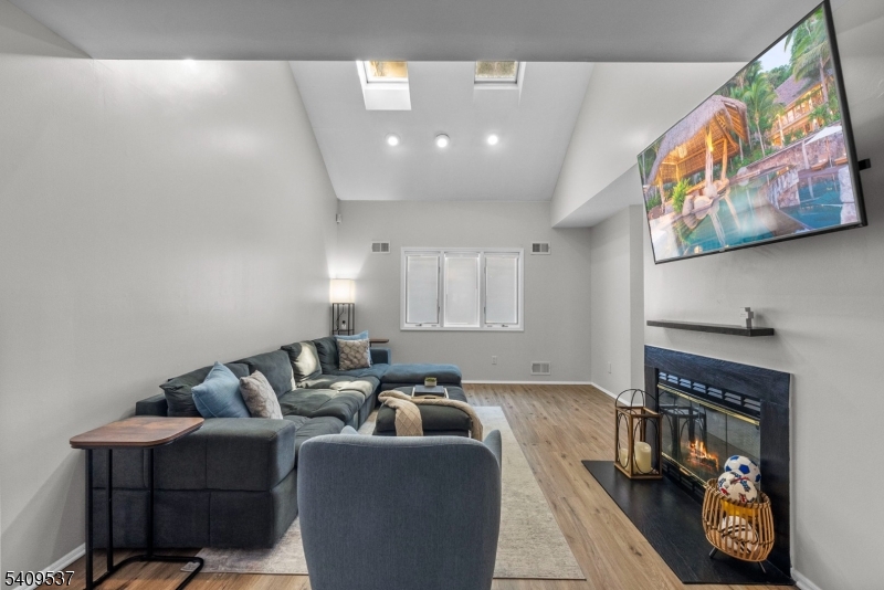 23 Bayowski Road West Orange, NJ 07052 - Photo 14 of 38 a living room with furniture and a fireplace