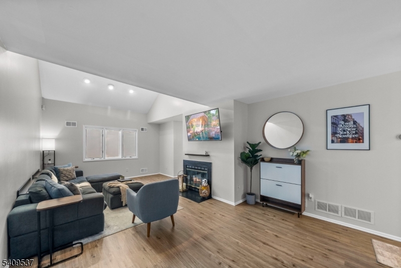 23 Bayowski Road West Orange, NJ 07052 - Photo 15 of 38 a living room with furniture a window and a fireplace