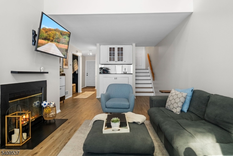 23 Bayowski Road West Orange, NJ 07052 - Photo 18 of 38 a living room with furniture a flat screen tv and a fireplace