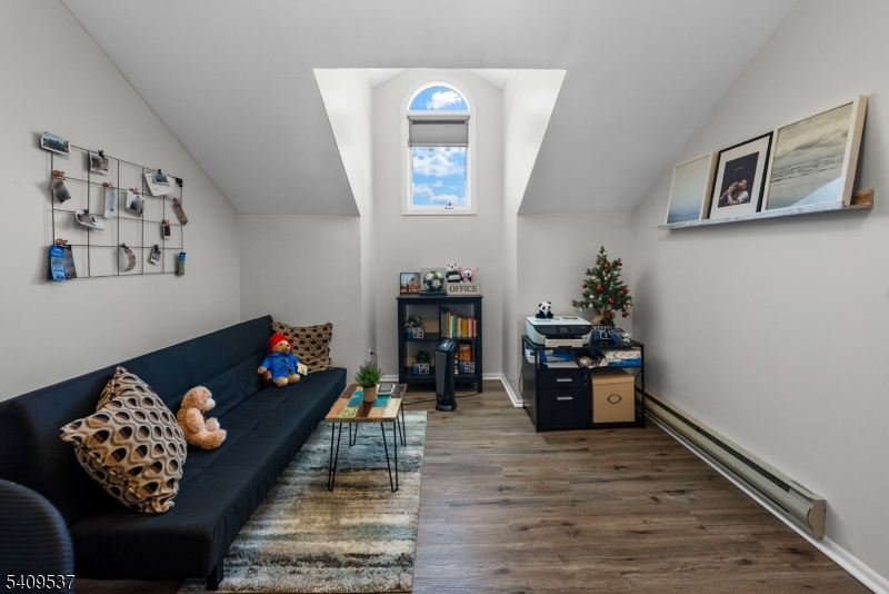 23 Bayowski Road West Orange, NJ 07052 - Photo 22 of 38 a living room with furniture and painting on the wall