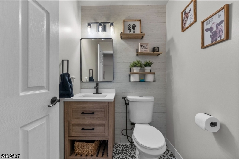 23 Bayowski Road West Orange, NJ 07052 - Photo 10 of 38 a bathroom with a toilet a sink and mirror