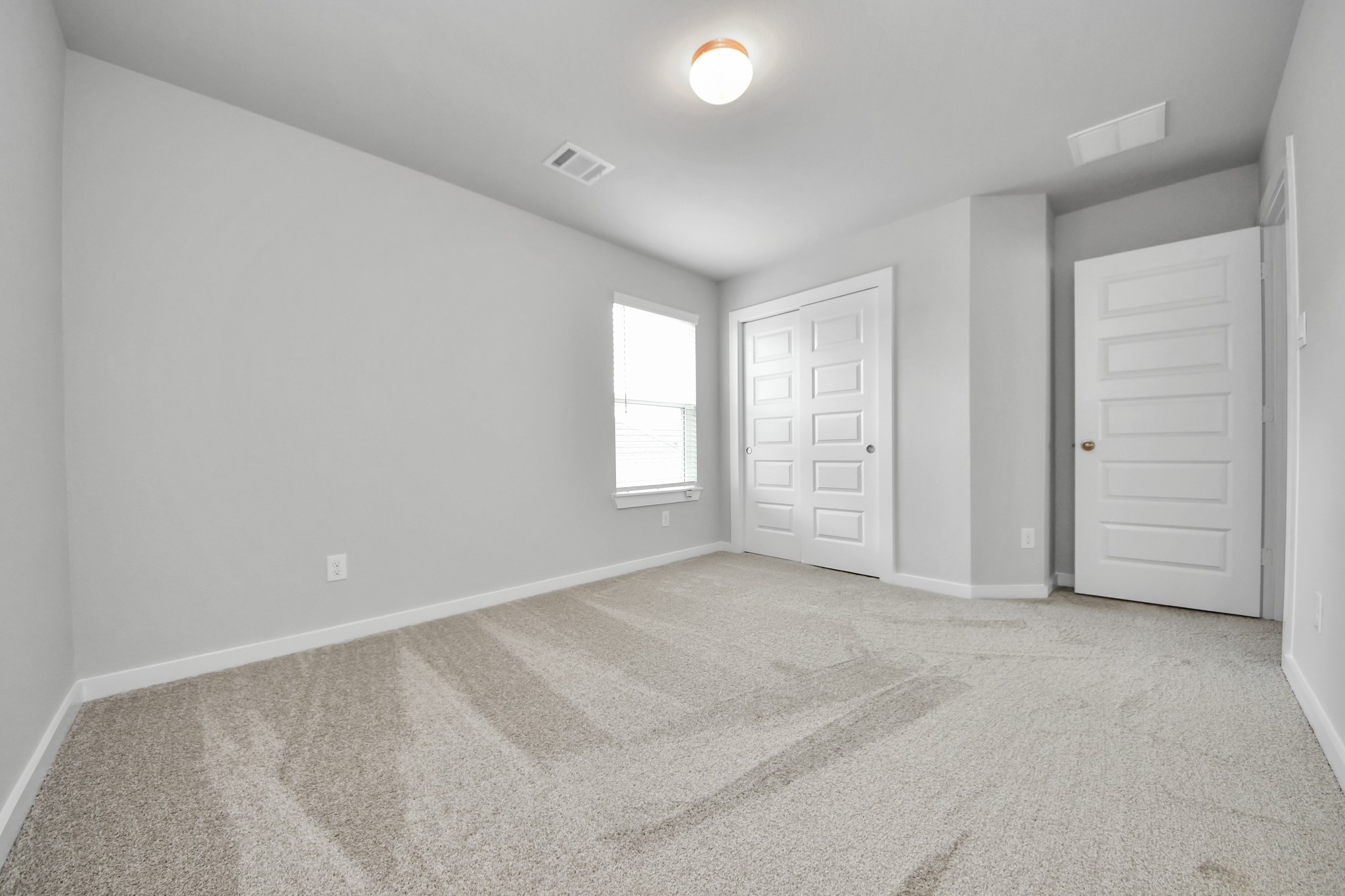 11106 Tulip Rdg Trail Houston, TX 77044 - Photo 29 of 34 Generously sized secondary bedrooms featuring spacious closets, soft and inviting carpeting underfoot, large windows allowing plenty of natural light, and the added touch of privacy blinds for your personal retreat. Sample photo of completed home with similar floor plan. Actual colors and selections may vary.