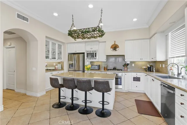 a kitchen with kitchen island granite countertop a table and chairs in it