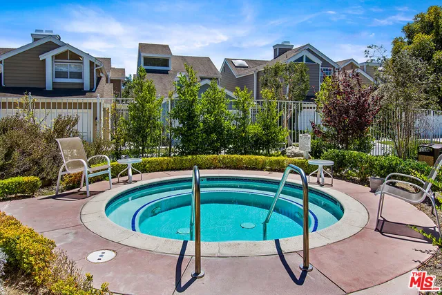 a view of a swimming pool with a patio and a garden