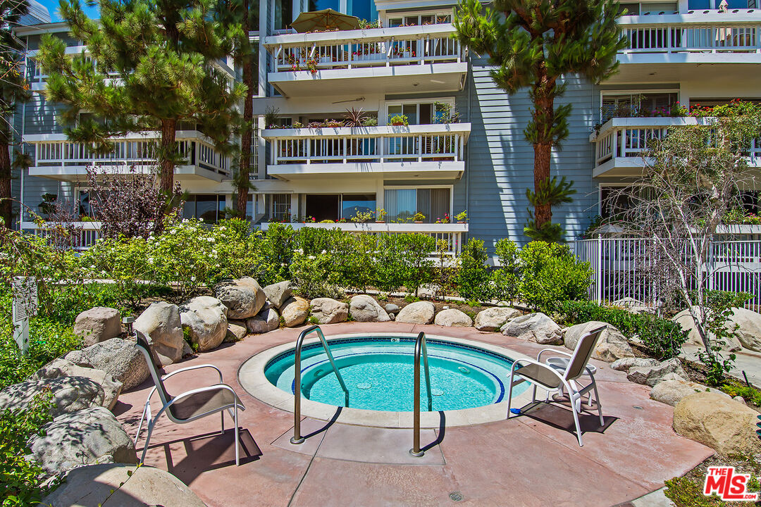 13080 Mindanao Way, Unit 95 Marina del Rey, CA 90292 - Photo 5 of 11 a view of a patio with a table and chairs under an umbrella