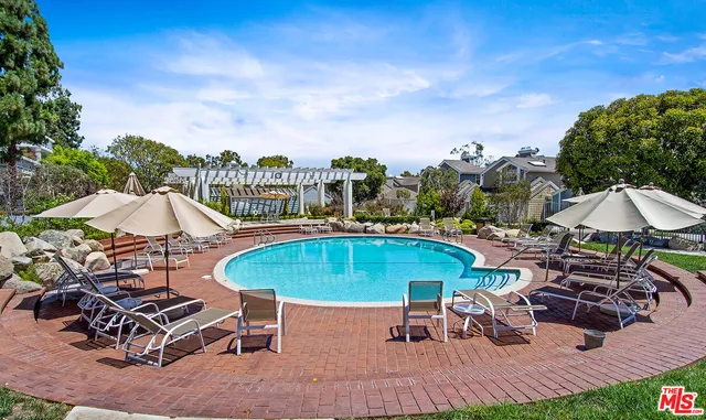 an outdoor space with pool and furniture